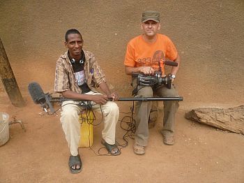 photo of Trond Waage sitting with camera on lap next to sound guy